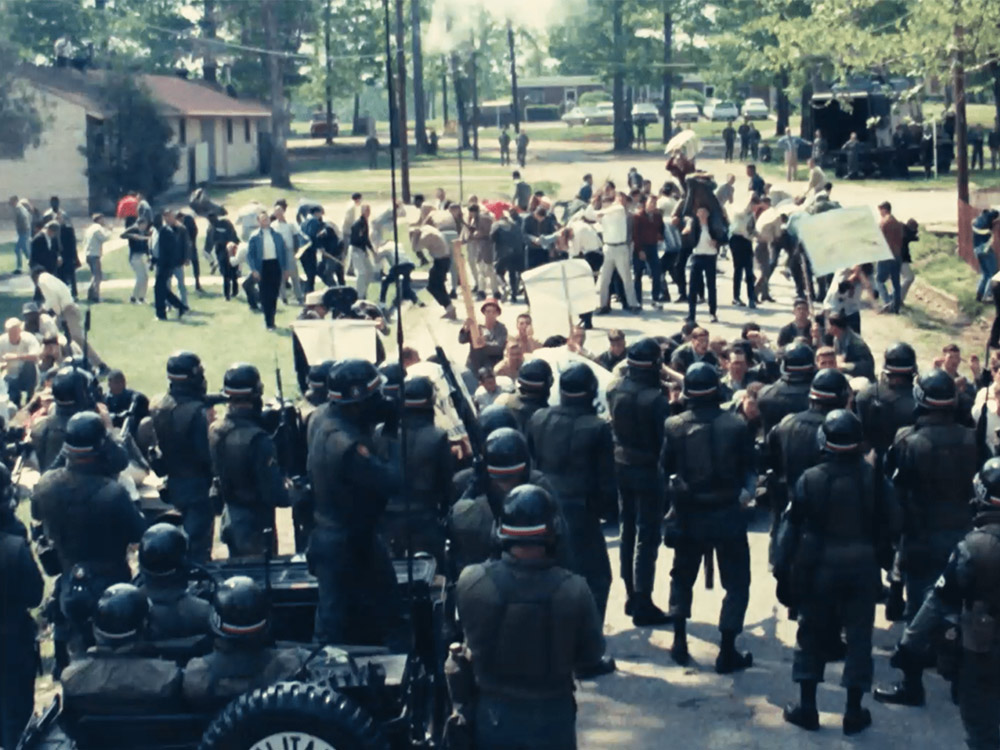 Protestors confronting riot police in suburbia